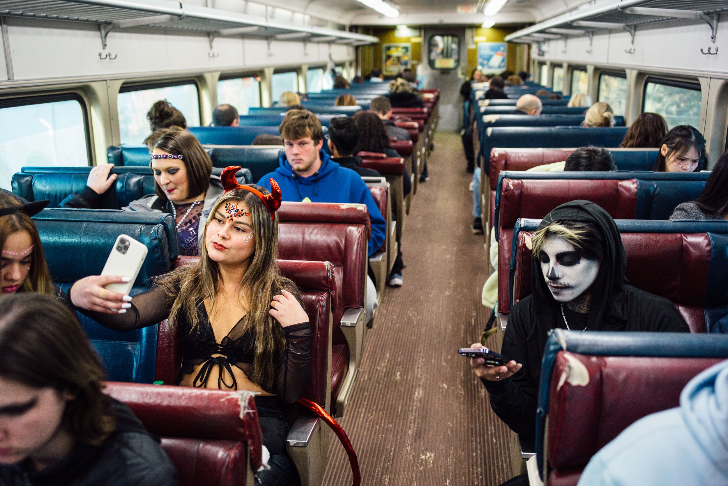 Passengers in costume ride a Commuter Rail train to Salem