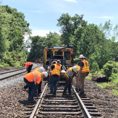 Commuter Rail employees working on a rail